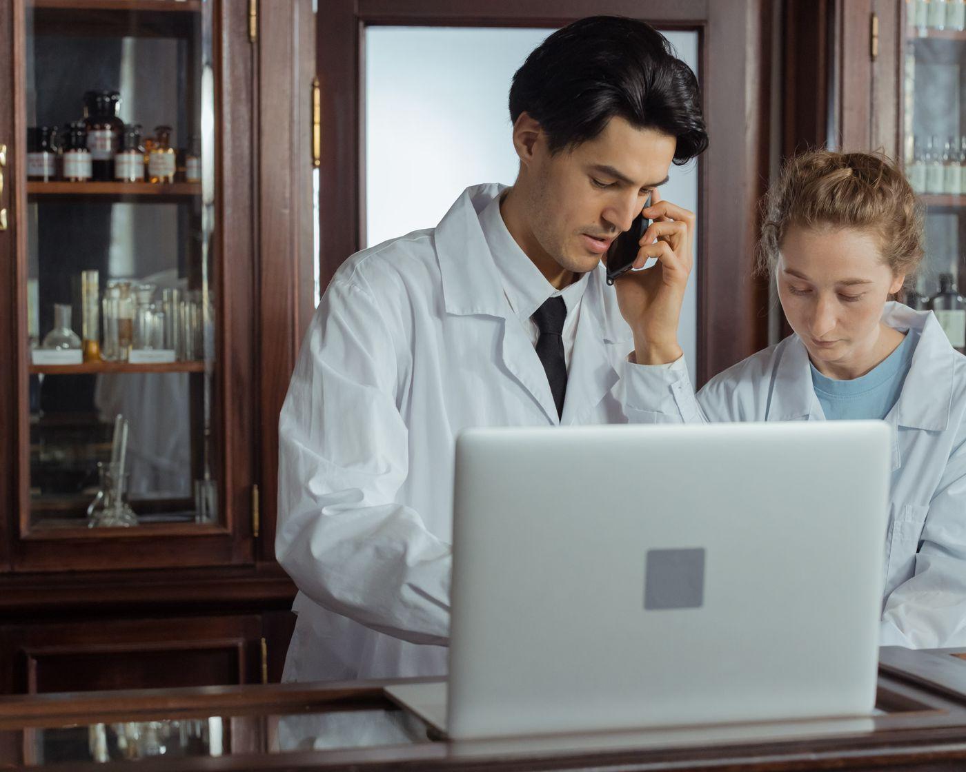 Pharmacists collaborating at a pharmacy counter
